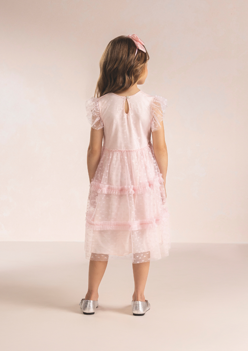 Costas do vestido infantil rosa de festa com fechamento delicado e forro macio de algodão.