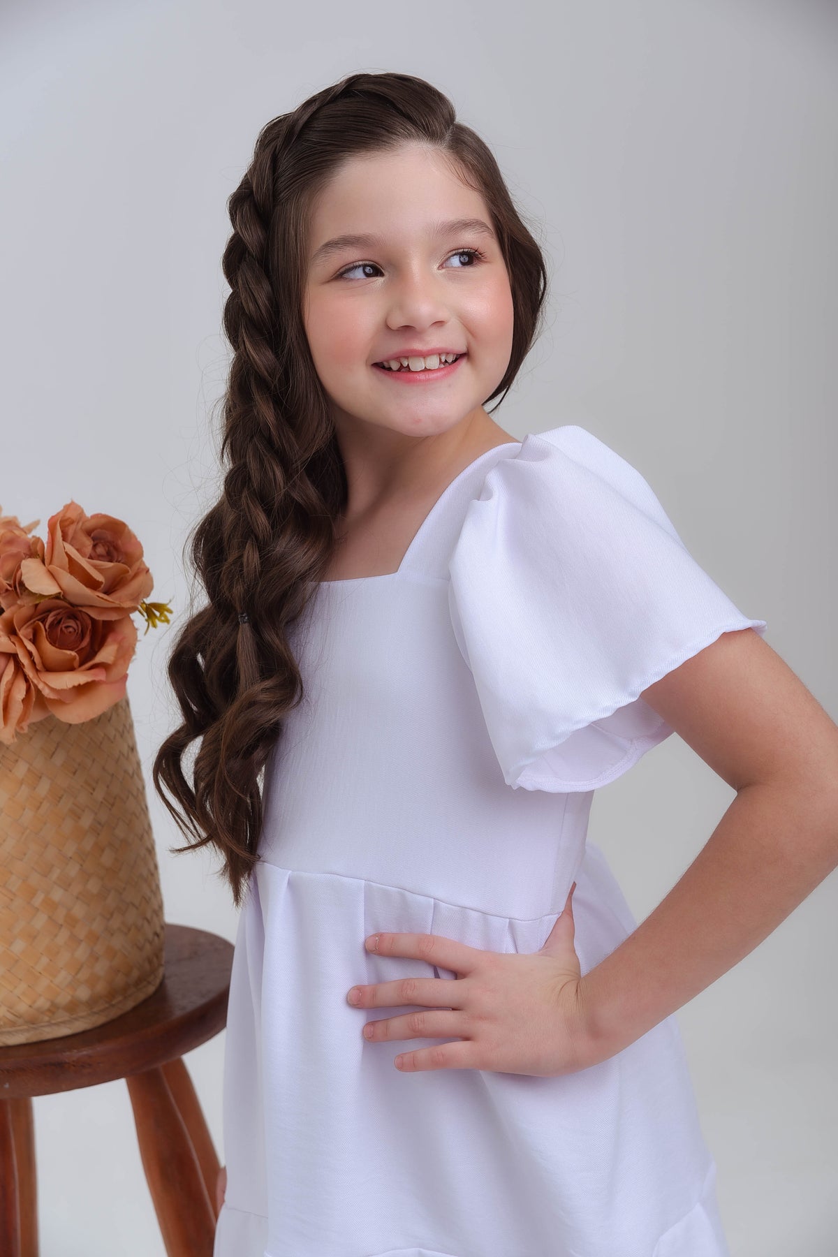 menina fazendo pose usando vestido branco